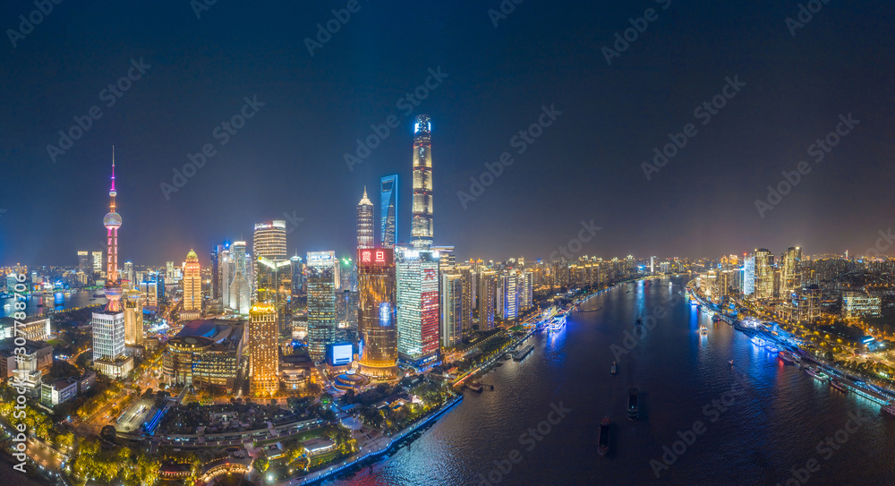 Fototapeta The night view of the city on the huangpu river bank in the center of Shanghai, China