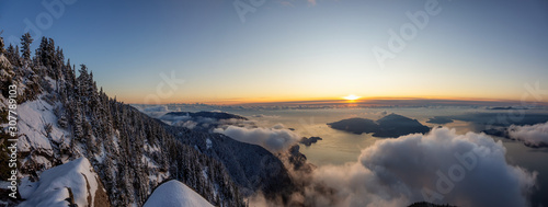 St Mark's Summit, in Howe Sound, North of Vancouver, British Columbia, Canada. Panoramic Canadian Mountain Landscape View from the Peak during cloudy winter sunset. © edb3_16