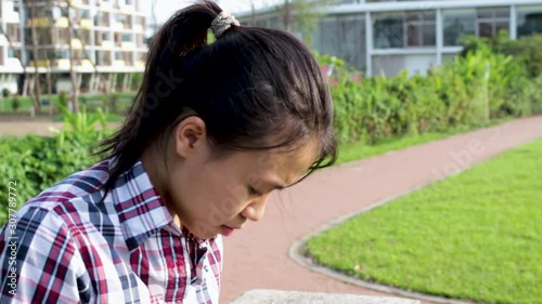 Asian girl sitting down getting phone call and worry and sad and cry