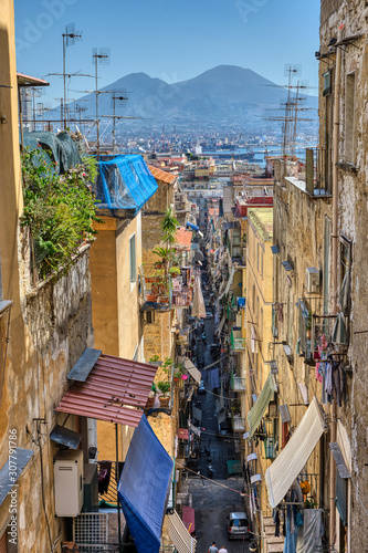 Small alleyway in the old town of Naples with Mount Vesuvius in the back photo