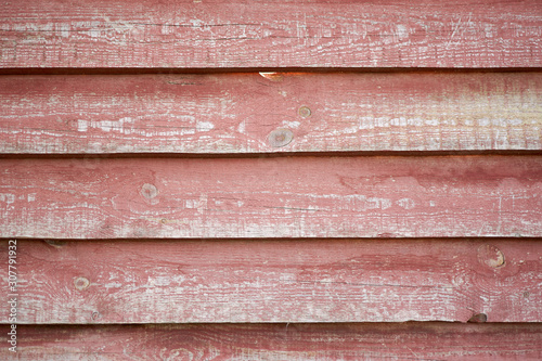 old wooden clapboard painted with burgundy paint photo