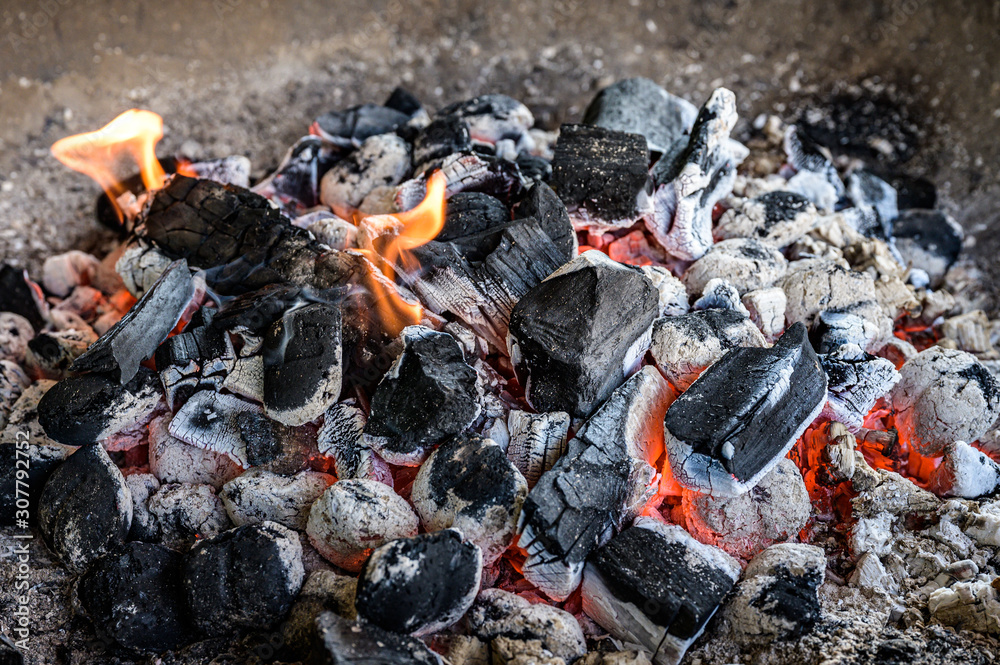 BBQ Grill Pit Glowing And Flaming Hot Charcoal Briquettes coal Food Background Or Texture Close-Up Top View BBQ Grill Pit Glowing And Flaming Hot Charcoal Briquettes coal Food Background Or Texture Close-Up Top View