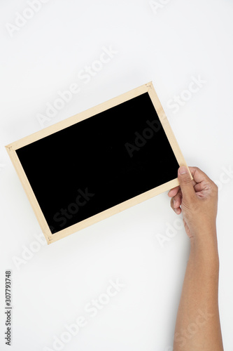 Mens hand holding blackboard over white background. Copy space concept