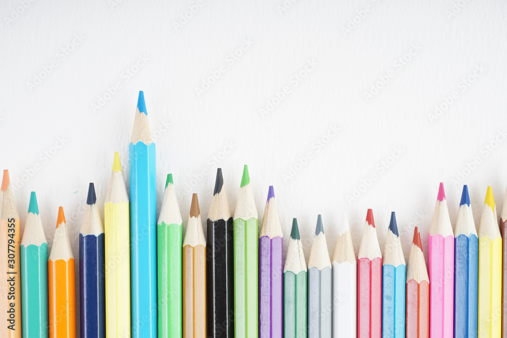 Rainbow colour pencils on the white paper over the white background Rainbow colour pencils on the white paper over the white background
