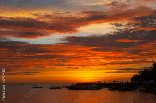 Amazing colorful sunset before an typhoon over coastal landscape with an lagoon in the foreground at Malandog on Panay island in the Philippines