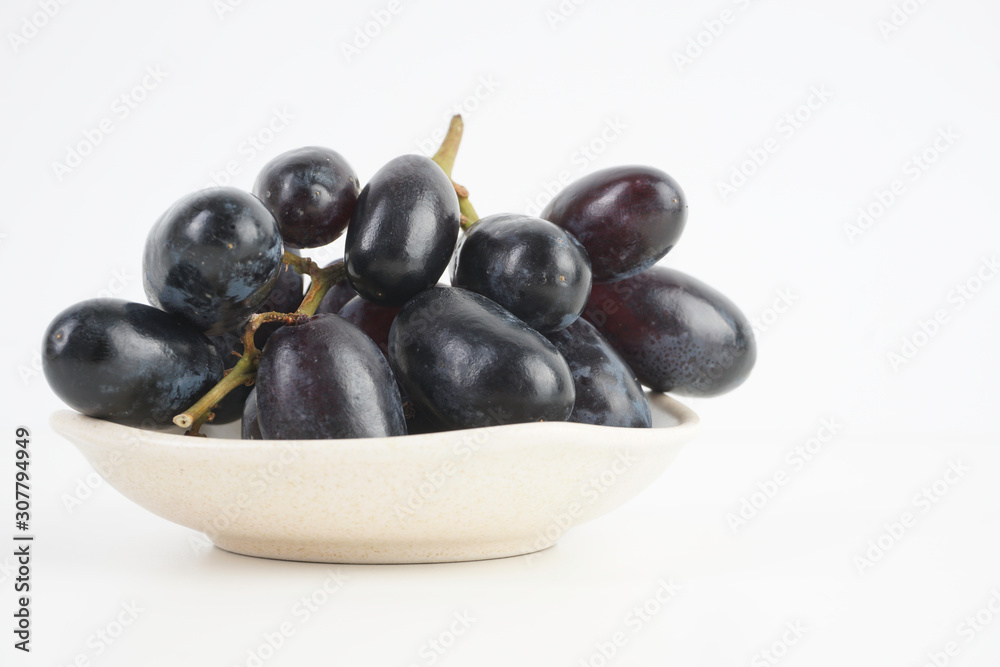 Fresh grape fruits plated over the white background