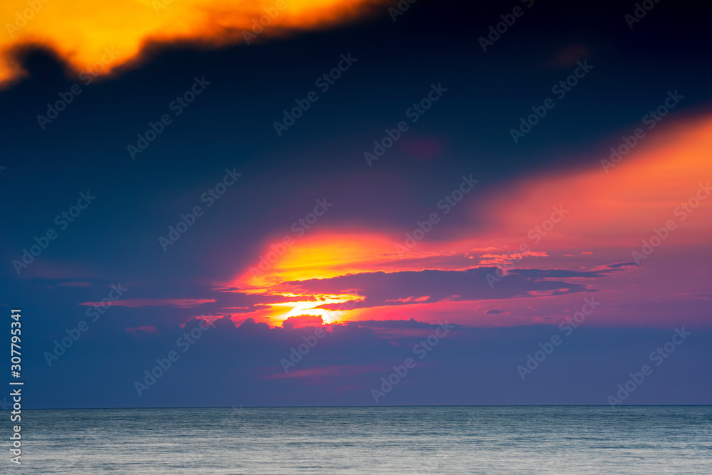 Amazing cloudy summer sunset over deep blue ocean and endless horizon, Baltic Sea Sweden