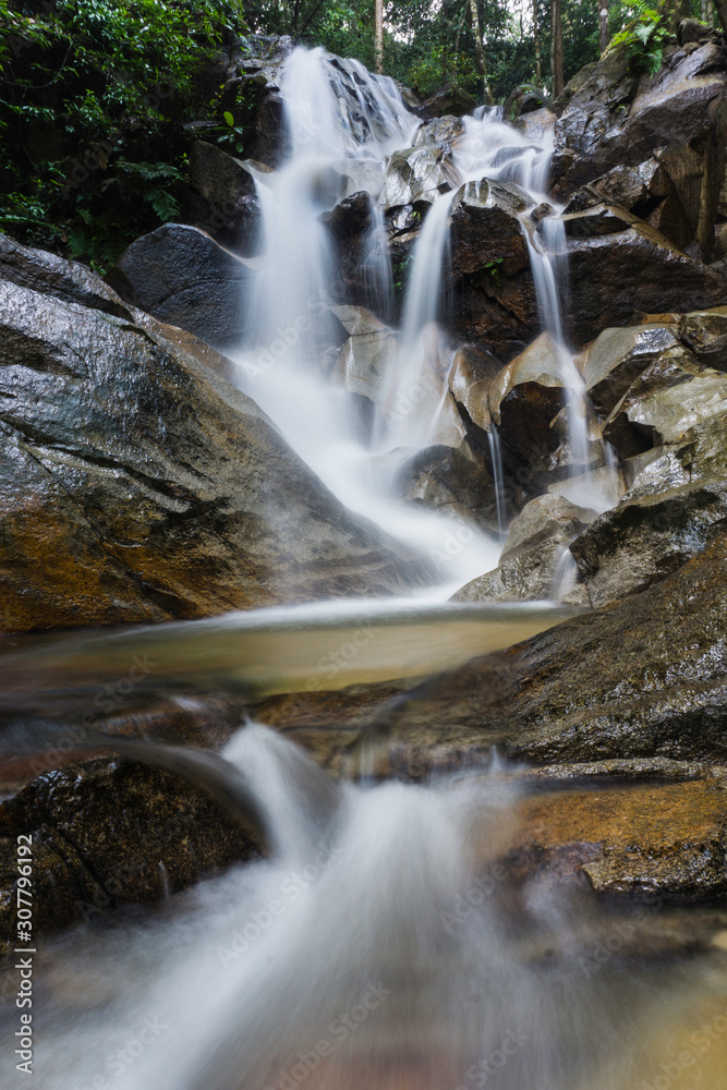 Fototapeta premium Beautiful waterfall view in the jungle. Long exposure image of water