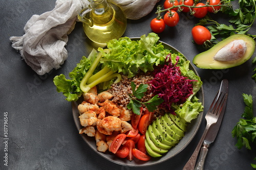 Buddha bowl or salad with red cabbage, cherry tomatoes, grilled chicken, avocado, lettuce,green pepper, parsley and buckwheat. Healthy food concept