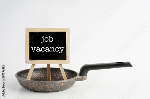 Frying pan and black board with 'We're hiring' wording over white background