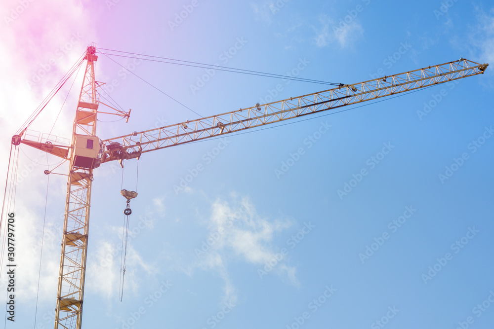 Construction crane close-up, against the blue sky. Concept of building construction, place for text, copy space Construction crane close-up, against the blue sky. Concept of building construction, place for text, copy space
