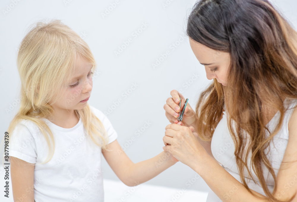 Mother clipping her fingernails to child Mother clipping her fingernails to child