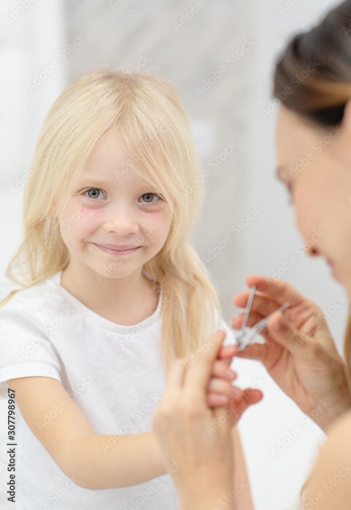mom cuts her nails child in the bedroom mom cuts her nails child in the bedroom