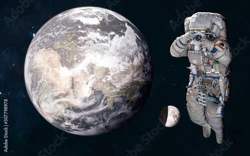 Astronaut on background of Earth and the Moon in warm light of Sun. 3D Render. Solar system. Science fiction. Elements of this image furnished by NASA