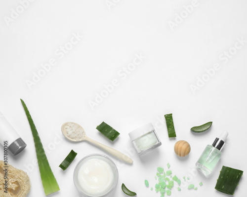 Flat lay composition with aloe vera and cosmetic products on white background