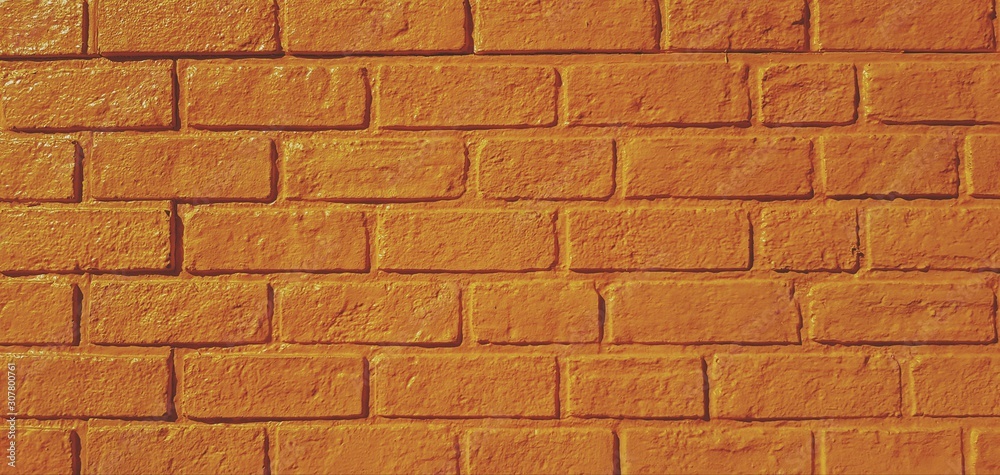 Obraz premium Pattern yellow brick wall painted for background in vintage tone. Art wallpaper and Architecture Exterior design concept 