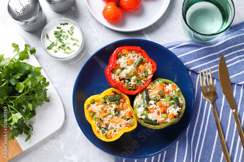 Tasty stuffed bell peppers served on grey table, flat lay
