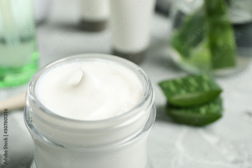 Open jar of aloe cream on table, closeup. Organic cosmetics Open jar of aloe cream on table, closeup. Organic cosmetics
