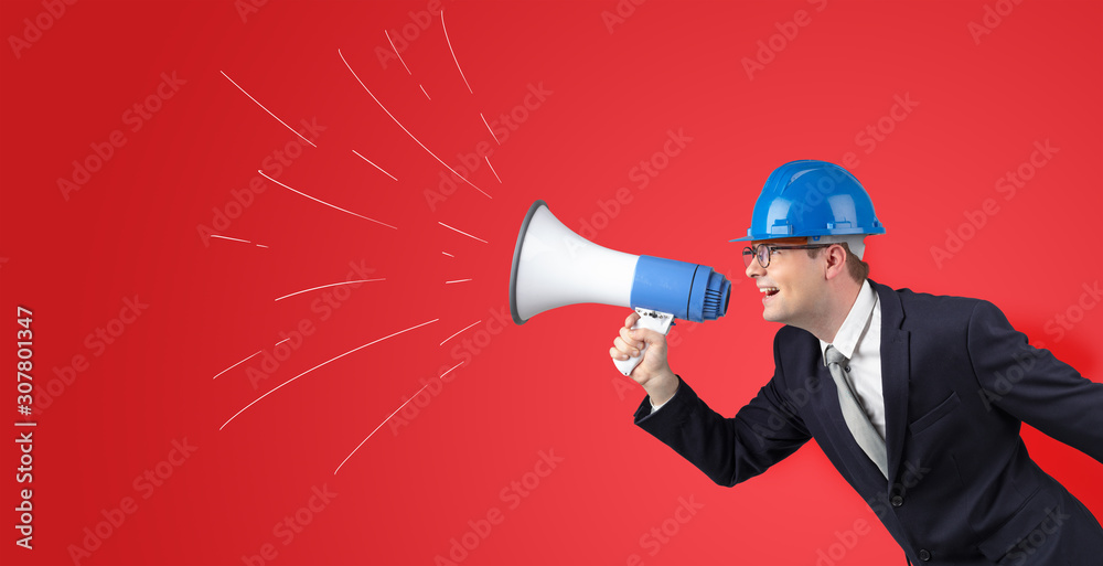 Fototapeta premium Young architect constructor yelling with megaphone and copyspace