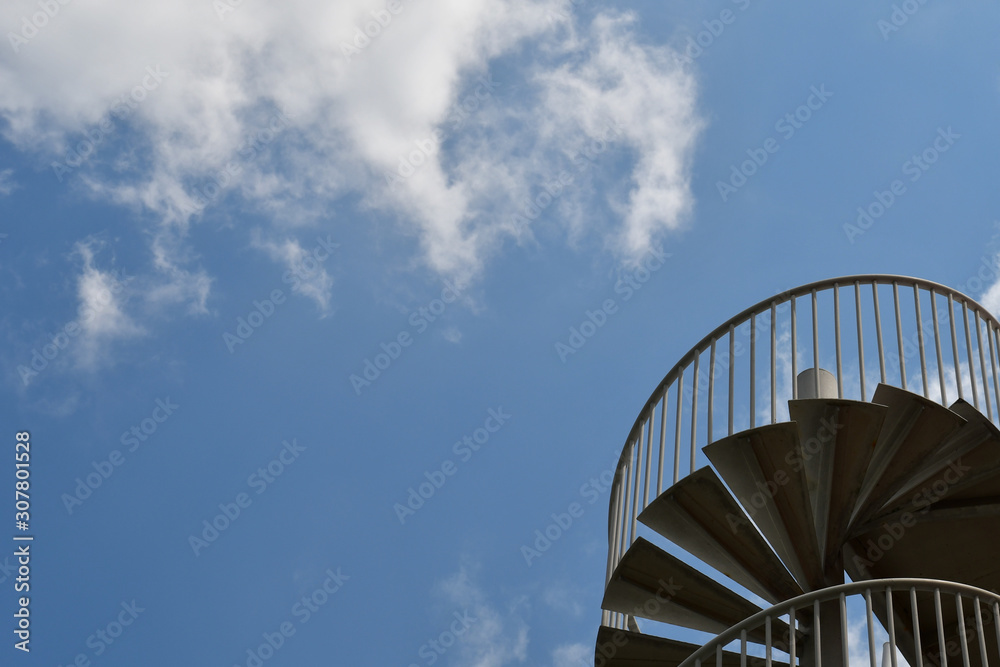 Blue sky and metal spiral staircase