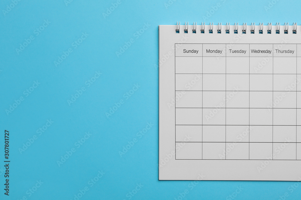 Blank calendar on light blue background, top view. Space for text Blank calendar on light blue background, top view. Space for text