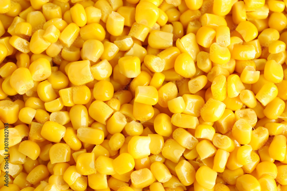 Delicious canned corn kernels as background, top view Delicious canned corn kernels as background, top view