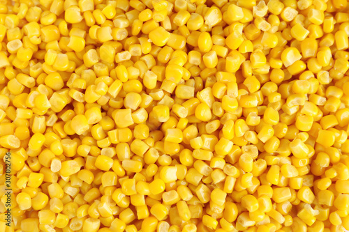 Delicious canned corn kernels as background, top view