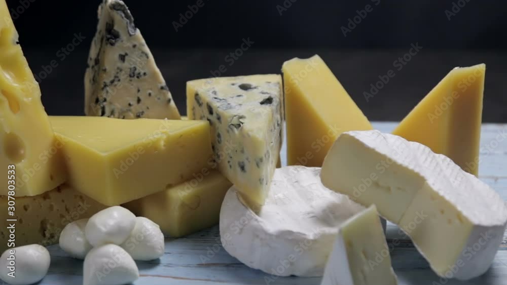 different varieties and types of cheese are on the table