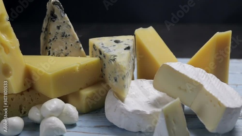 different varieties and types of cheese are on the table