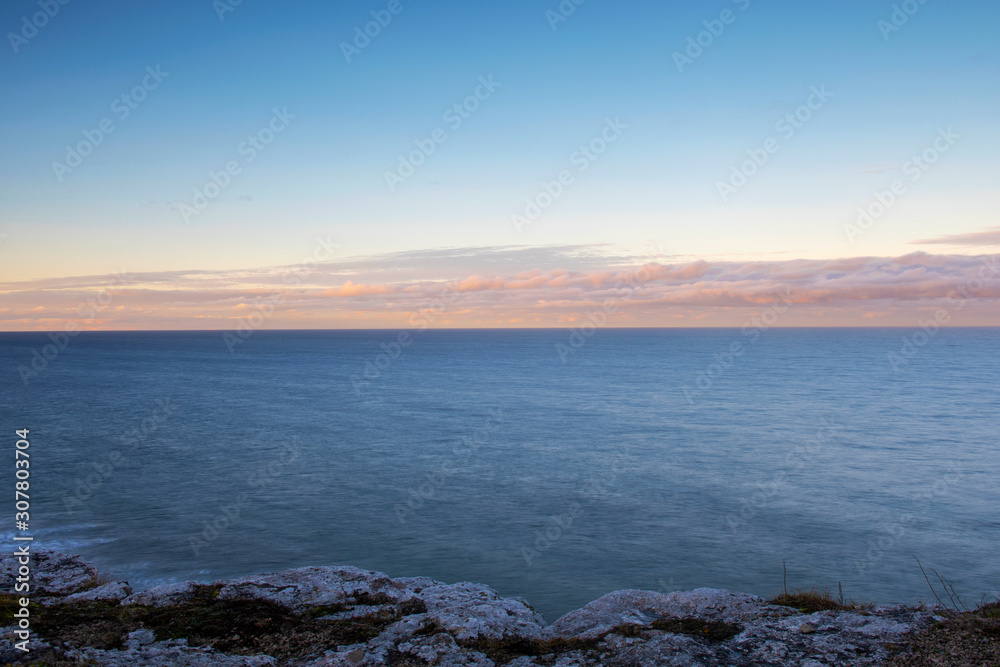 Limestone Cliff With Cloudy Sunrise Over Ocean