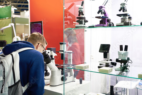 Man and microscopes in store photo