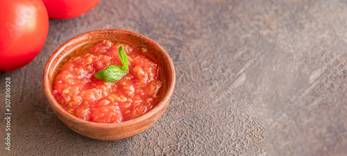 Close up of tomato souse popular ingredient in Mediterranean cousin on dark background photo