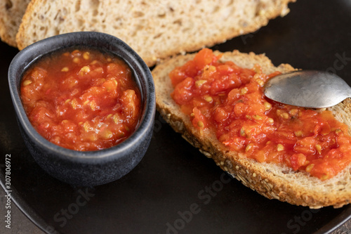 Pa amb tomaquet or tomaca (bread with tomato) classic snack in Catalan and Spanish cuisine, eaten for breakfast. photo