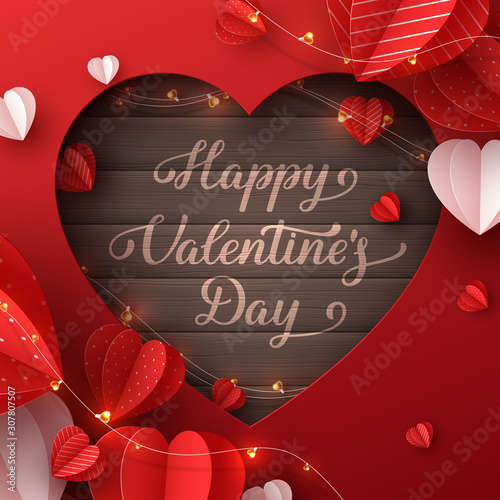 Happy Valentines day greeting card. Decorative paper cut hearts with garland and handwritten lettering text on brown wooden background. Vector illustration.