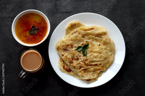 Top view of roti canai, teh tarik and curry