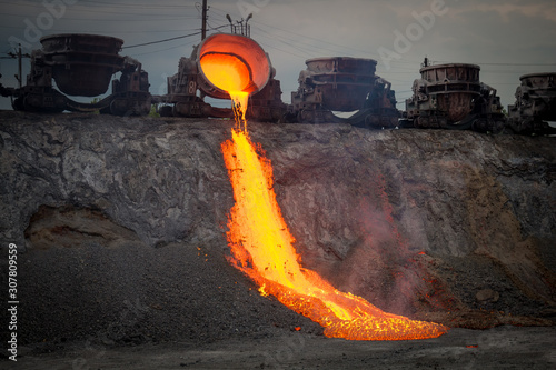 Discharge of metallurgical slag from blast furnaces. Beautiful stream of hot slag photo