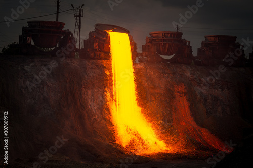 Discharge of metallurgical slag from blast furnaces. Beautiful stream of hot slag