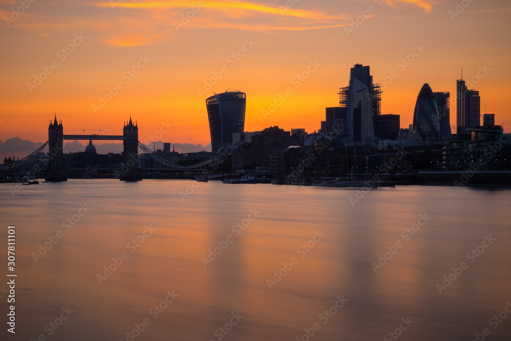 Long exposure, silhouette of London cityscape with river Thames