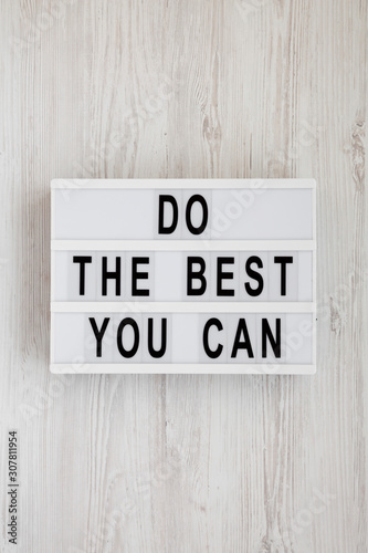 'Do the best you can' words on a modern board on a white wooden background, top view. Overhead, from above, flat lay.