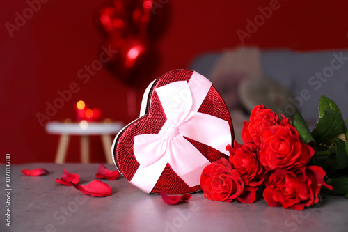 Fototapeta Naklejka Na Ścianę i Meble -  Marry me concept, wedding / engagement ring with red candles, roses bouquet, heart shaped air balloon. Happy st. valentine's day concept. Close up, copy space, front view