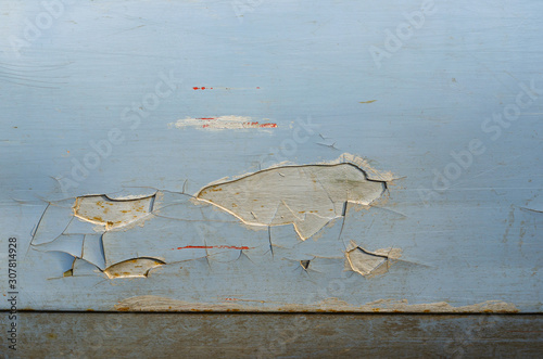 Old car door. Door with a breakaway thick layer of putty. An old, painted car many times. Close-up. Horizontal photo layout.