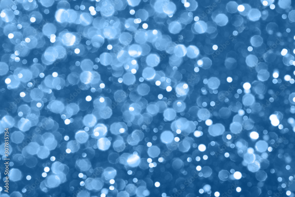 Blue festive background with sparkles in the bokeh. The concept of the celebration, the day of Christmas, New Year, birthday, ceremonies, events, etc.