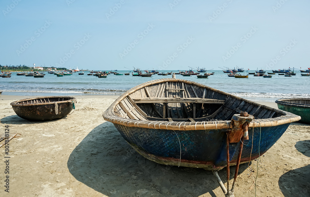 Basket fishing boat. A traditional Vietnamese fishing boat basket on the beach. These boats are still used by Vietnamese fishermen and are driven by only one oar.