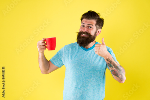 Cappuccino with right proportion of milk. True specialty coffee is becoming big business. Energy concept. Hipster barista yellow background. Coffee shop. Bearded man drink morning coffee. Tea time