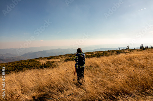 Woman tourist photographer on a mountain. © zane38