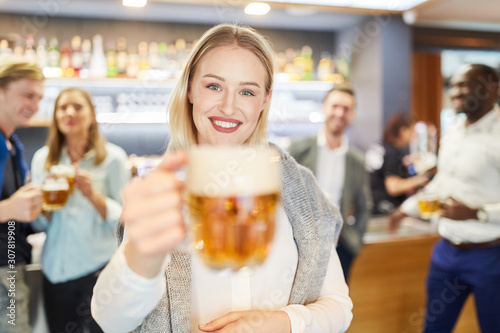 Cheerful woman tasting with a glass of beer