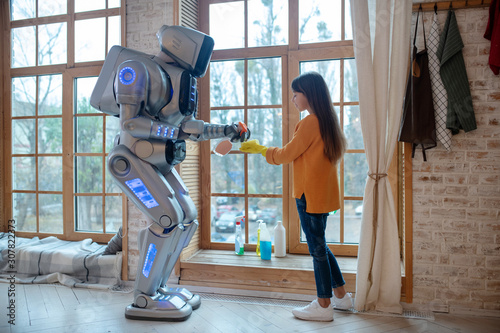 Obraz na płótnie Robot spraying liquid for cleaning on the sponge