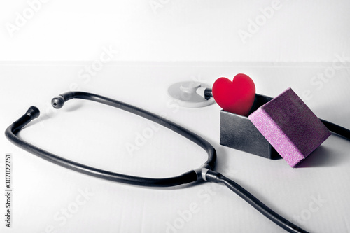 red heart in a gift box inside a statoscope on a white background.. photo