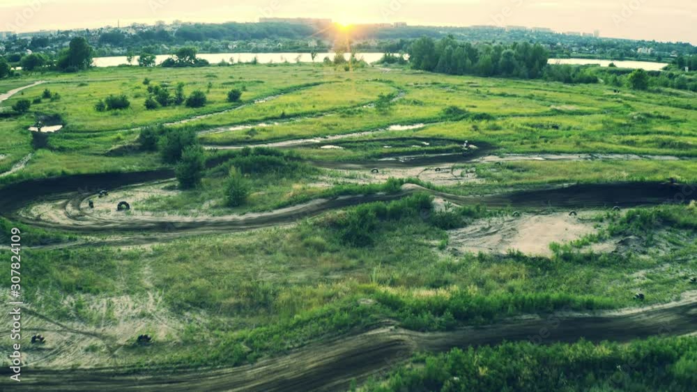 Motocross motorcycles training on a track, shot from above Motocross motorcycles training on a track, shot from above