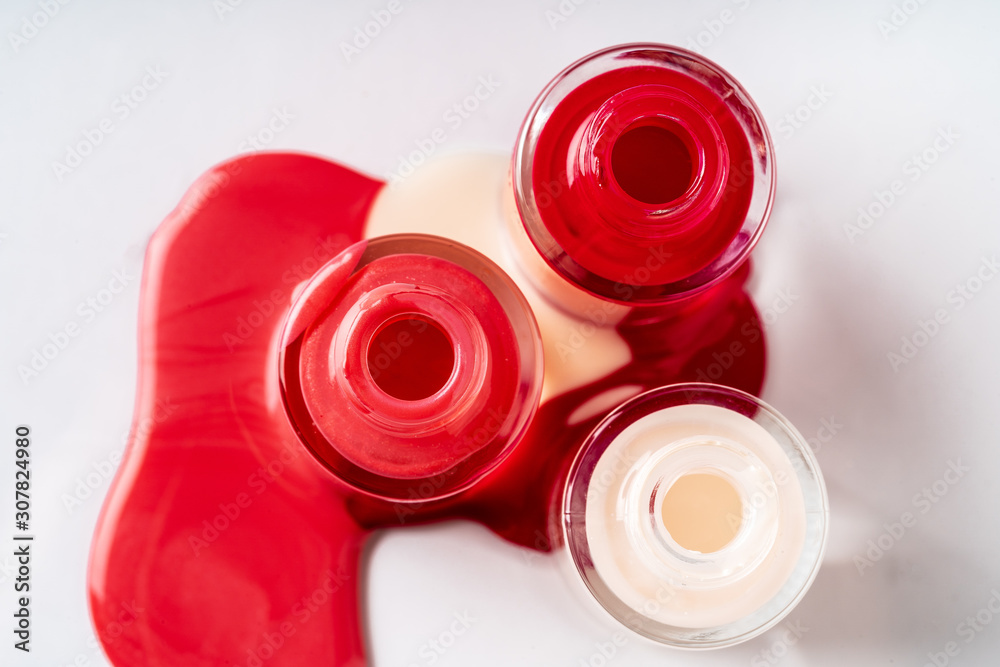 Several opened bottles of nail polish on white background Several opened bottles of nail polish on white background
